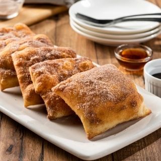 Sopapillas: 2 or 5 Mexican pastries coated in cinnamon-sugar. Served with honey and chocolate sauce for dipping.