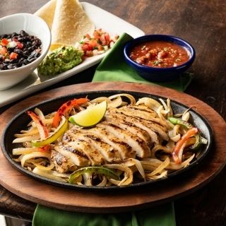 Border Smart Chicken Fajitas: Mesquite-grilled chicken with sautéed onions and bell peppers. Served with black beans, white corn tortillas, pico de gallo and guacamole.
