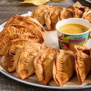 Empanada Platter: 24 handmade pastries filled with mixed cheese and seasoned ground beef. Served with signature queso.