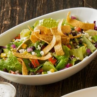 House Salad: A crisp blend of lettuce & shredded cabbage and pico de gallo. Topped with crispy tortilla strips and queso fresco and your choice of dressing.