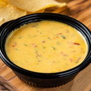 Queso: Our mouthwatering queso, available as an individual side or a quart.