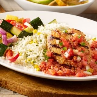 Mexican Grilled Chicken: Mesquite-grilled chicken breast topped with pico de gallo and house-made salsa. Served with sautéed vegetables and cilantro lime rice.