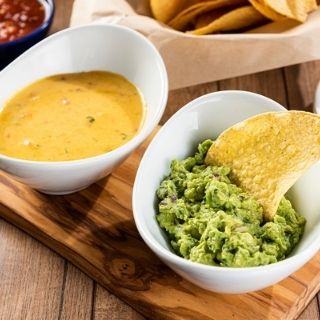 Guac/Queso Duo: The best of both worlds. A cup of Signature Queso and a cup of fresh Guacamole served with a side of chips.