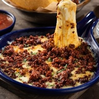Melted Queso Fundido: Melted Mexican and Jack cheeses mixed tableside with caramelized onions, poblano peppers and chorizo. Served with fresh hand-pressed flour tortillas.