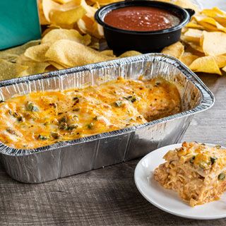 King Ranch Casserole: Layers of white corn tortillas, sour cream sauce, chicken tinga, poblano & onion, queso and melted mixed cheese. Served with our famous chips & salsa and choice of rice & beans or a house salad.