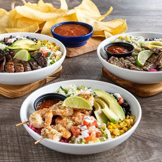 Bolder Border Bowls at OTB: Cilantro lime rice, black beans, pickled red onions, toasted corn, queso fresco, shredded lettuce, pico de gallo, lime crema and sliced avocado topped with your choice of protein. Choose from mesquite-grilled chicken, portobello, shrimp or steak, brushed with lime-cilantro chimichurri.
