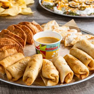 Mexican Sampler Platter: 24 pieces. Mini chicken quesadillas, beef or chicken empanadas and beef or chicken mini chimis. Served with queso.