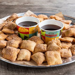 Mini Sopapilla Platter: 48 fluffy Mexican pastries, sprinkled with cinnamon-sugar. Served with chocolate sauce and honey for dipping.