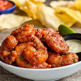 Crispy Honey Chipotle Shrimp: Crispy fried shrimp, hand-tossed in honey-chipotle sauce and sprinkled with fresh cilantro. Served with spicy avocado ranch for dipping.
