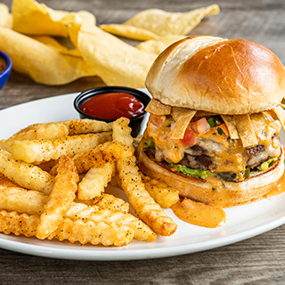 Loaded Queso Burger: Our Tex-Mex burger loaded with fresh guacamole, pico de gallo, tortilla strips pickled jalapeños, Mexican white cheese and covered in Signature Queso. Served with fries.