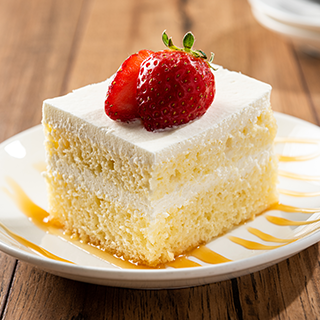 TresLeches Cake: A Mexican tradition. A light cake soaked in three kinds of sweet milk, topped with whipped cream and strawberry.