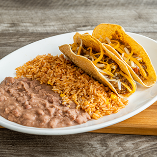 Kids Tacos: Two crispy taco shells, ground beef, and mixed cheese. Served with Mexican rice and refried beans. Lettuce and tomatoes are available upon request.