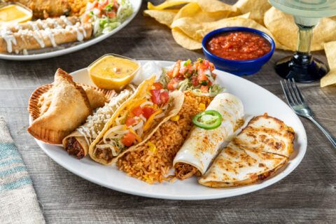 Gran Papi: Cheese quesadilla, chicken tinga enchilada with sour cream sauce, seasoned ground beef taco, crispy or soft, chicken flauta and beef empanadas. Served with Mexican rice.